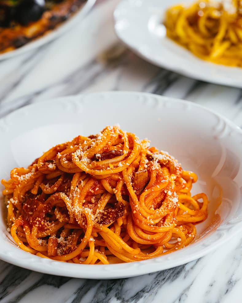 Close-up photo of plates of pasta.