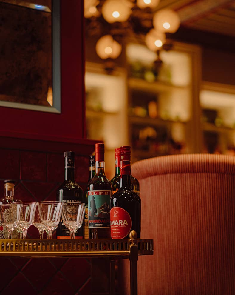 Mother Wolf interior, with various alcoholic drinks visible in the front.